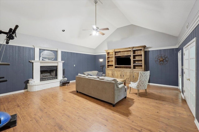 132 County Road 760, Buna, TX 77612 - living room featuring wood finished floors, ceiling fan, a brick fireplace, and vaulted ceiling