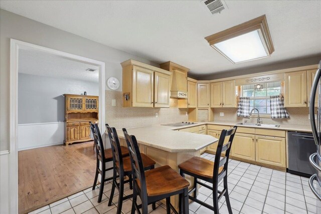 132 County Road 760, Buna, TX 77612 - kitchen featuring a sink, visible vents, light brown cabinets, light countertops, and dishwashing machine