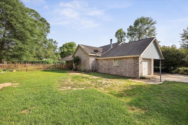 132 County Road 760, Buna, TX 77612 - view of side of home with brick siding, a lawn, a garage, and fence