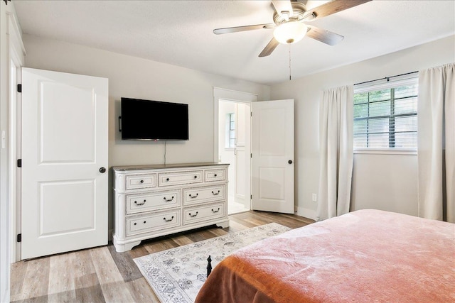 bedroom with ceiling fan and light wood-type flooring