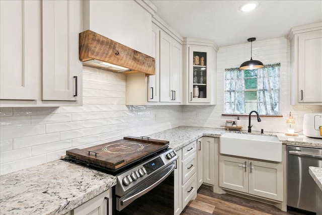 kitchen featuring pendant lighting, white cabinetry, appliances with stainless steel finishes, and sink