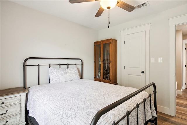 bedroom with ceiling fan and dark hardwood / wood-style floors