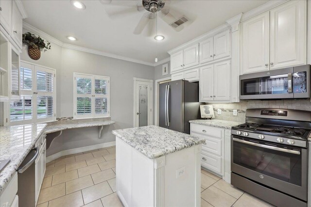 11 Regency Pl, Orange, TX 77630 - bedroom with wood finished floors, a skylight, multiple closets, baseboards, and ornamental molding