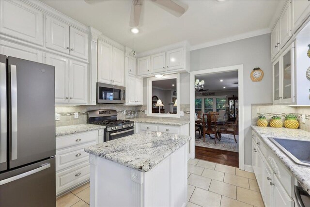 11 Regency Pl, Orange, TX 77630 - unfurnished bedroom featuring a skylight, ornamental molding, multiple closets, wood finished floors, and baseboards