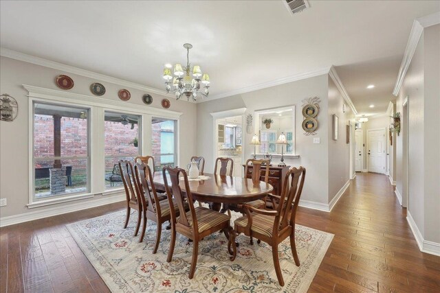 11 Regency Pl, Orange, TX 77630 - dining room featuring a ceiling fan, wood finished floors, a chandelier, baseboards, and ornamental molding