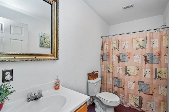 bathroom with curtained shower, vanity, and toilet