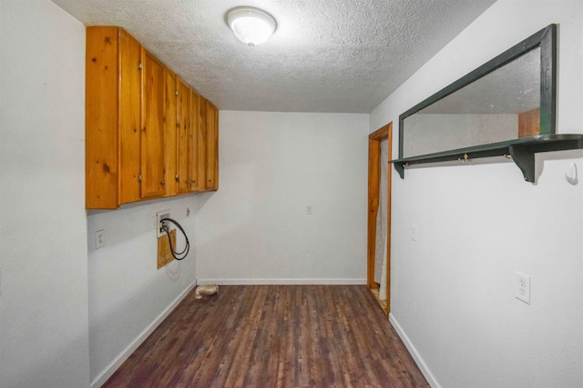 washroom featuring dark hardwood / wood-style flooring, a textured ceiling, and hookup for a washing machine