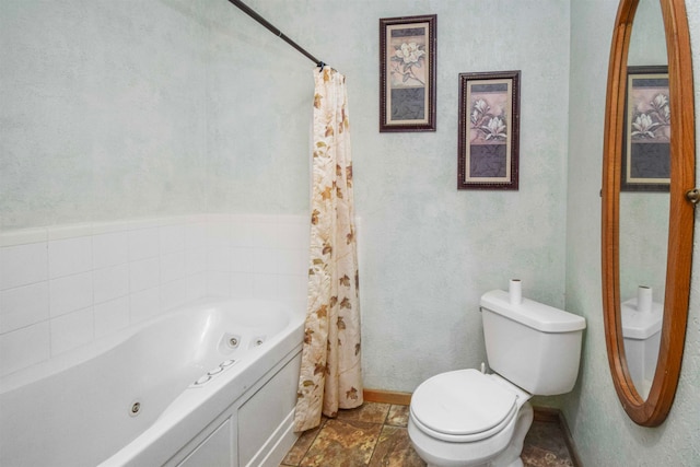 bathroom featuring tile patterned flooring, toilet, and a bath