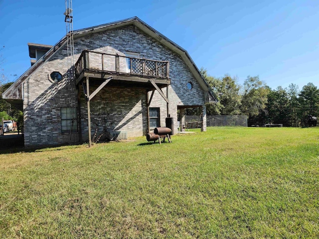 back of property featuring a yard and a wooden deck