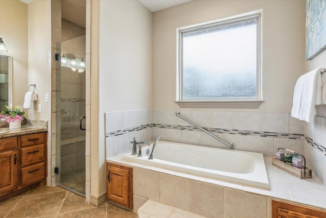 full bathroom featuring vanity, a garden tub, and a shower stall