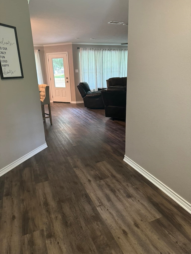 corridor with crown molding and dark hardwood / wood-style flooring