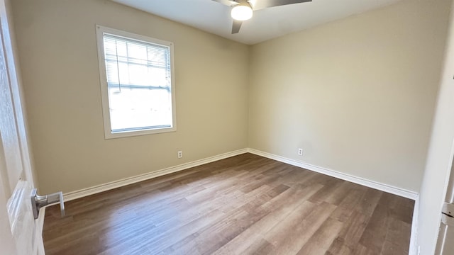 spare room featuring wood-type flooring and ceiling fan