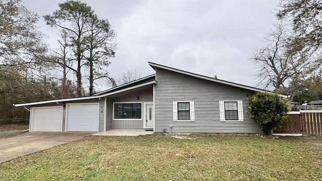 single story home featuring a garage and a front yard