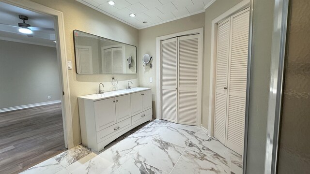 bathroom with vanity, crown molding, and walk in shower