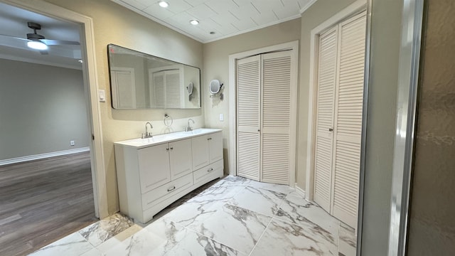 bathroom with crown molding, ceiling fan, and vanity