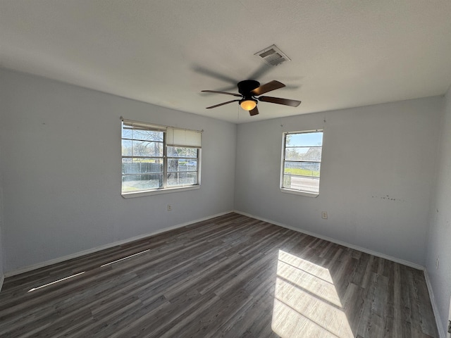 385 Warner St, Bridge City, TX 77611 - unfurnished room with plenty of natural light, dark wood finished floors, and ceiling fan