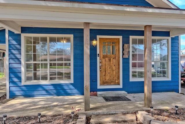 view of exterior entry with a porch