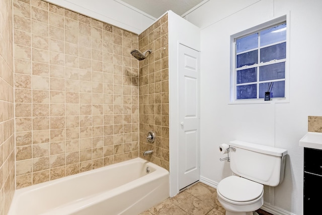 full bathroom with vanity, tiled shower / bath, and toilet