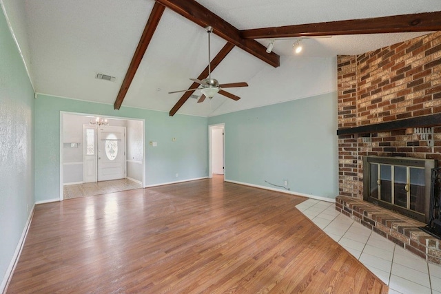 652 Birchwood Dr, Port Neches, TX 77651 - unfurnished living room featuring wood finished floors, a chandelier, a ceiling fan, and a brick fireplace