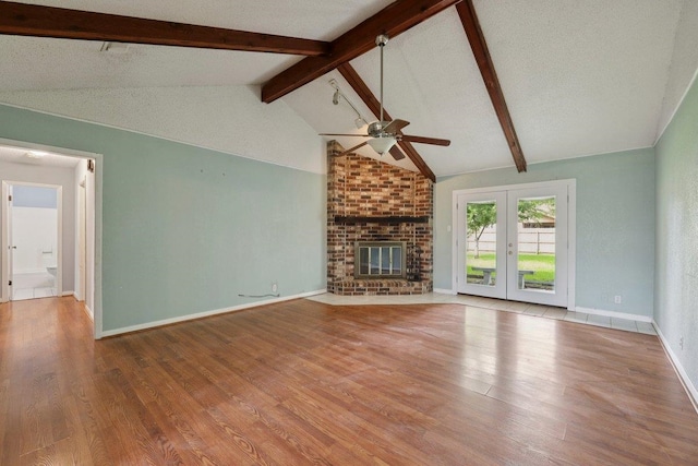652 Birchwood Dr, Port Neches, TX 77651 - unfurnished living room featuring ceiling fan, wood finished floors, a fireplace, and french doors