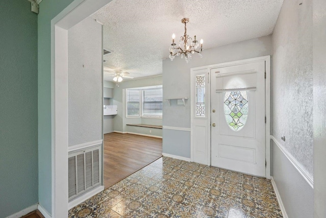 652 Birchwood Dr, Port Neches, TX 77651 - foyer entrance with a textured ceiling, a chandelier, and a ceiling fan
