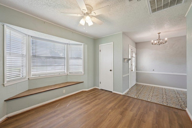 652 Birchwood Dr, Port Neches, TX 77651 - spare room with wood finished floors, a chandelier, a ceiling fan, healthy amount of natural light, and a textured ceiling