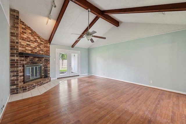 652 Birchwood Dr, Port Neches, TX 77651 - unfurnished living room featuring wood finished floors, a brick fireplace, and a ceiling fan