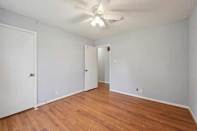 652 Birchwood Dr, Port Neches, TX 77651 - unfurnished bedroom with wood finished floors, a textured ceiling, and a ceiling fan