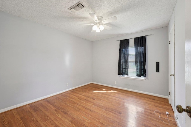 652 Birchwood Dr, Port Neches, TX 77651 - empty room featuring a ceiling fan, wood finished floors, and a textured ceiling