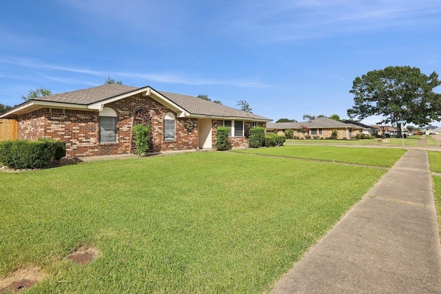 652 Birchwood Dr, Port Neches, TX 77651 - ranch-style house with a front lawn, brick siding, and roof with shingles