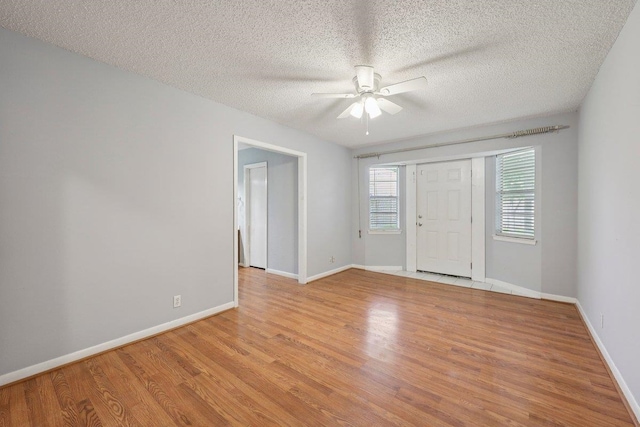 652 Birchwood Dr, Port Neches, TX 77651 - spare room featuring ceiling fan, light wood-style floors, and a textured ceiling