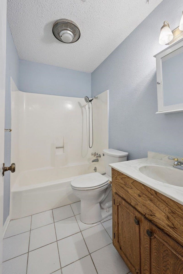 652 Birchwood Dr, Port Neches, TX 77651 - bathroom featuring vanity, bathtub / shower combination, a textured ceiling, and tile patterned flooring
