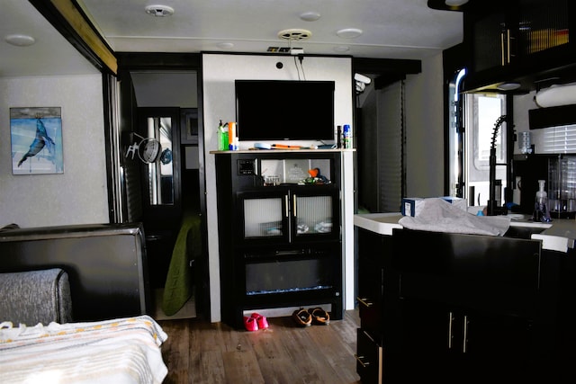 bedroom with dark wood-style floors and a sink