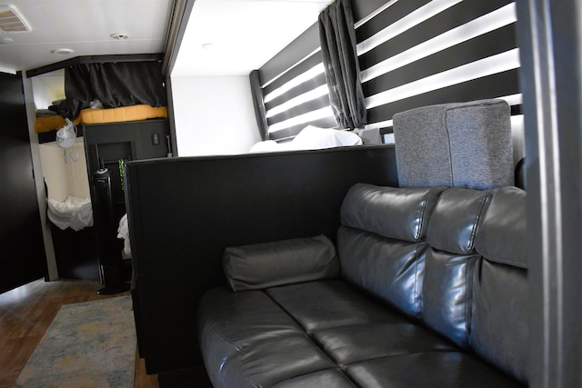 living room with dark wood-style floors and visible vents