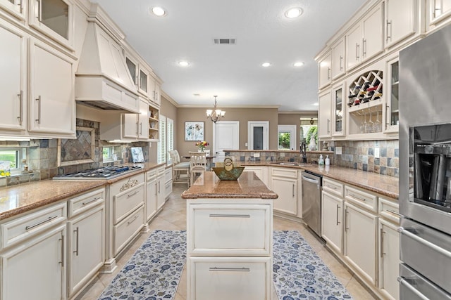 2425 Amberwood Dr, Beaumont, TX 77713 - kitchen featuring custom exhaust hood, recessed lighting, a sink, backsplash, and stainless steel appliances
