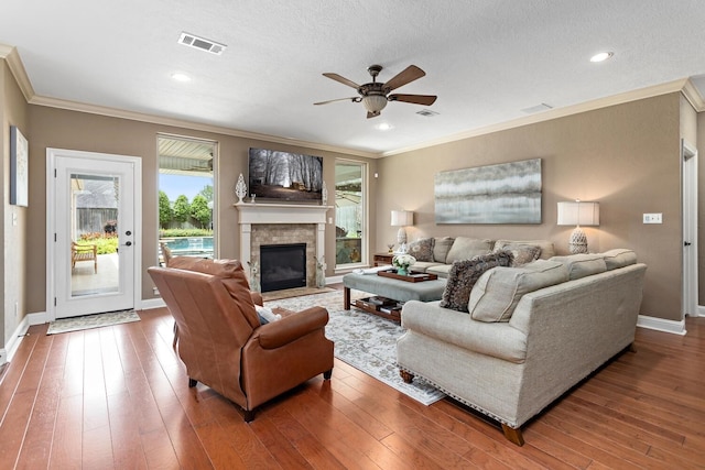 2425 Amberwood Dr, Beaumont, TX 77713 - living area featuring visible vents, wood-type flooring, crown molding, baseboards, and ceiling fan