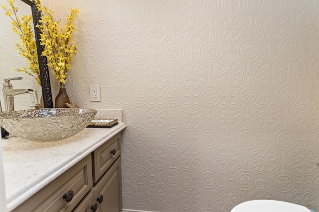 2425 Amberwood Dr, Beaumont, TX 77713 - bathroom featuring toilet, wallpapered walls, and vanity