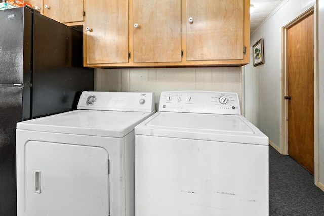 clothes washing area featuring cabinet space and washer and dryer