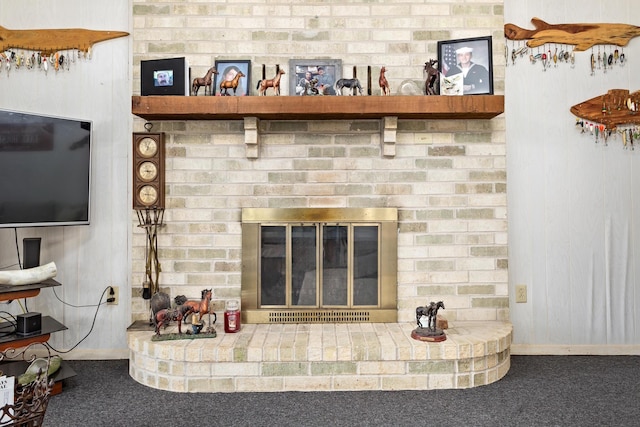 interior details featuring a brick fireplace, carpet, and baseboards