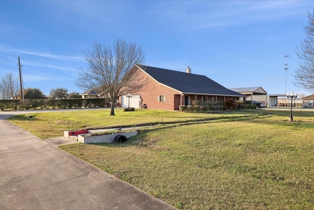 view of side of property featuring a yard