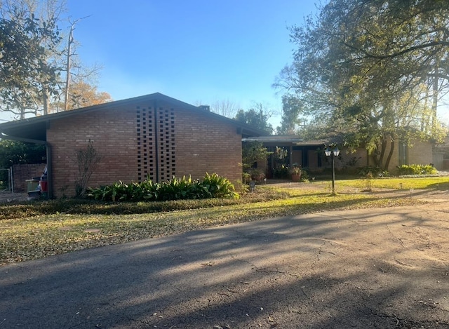 view of property exterior featuring brick siding