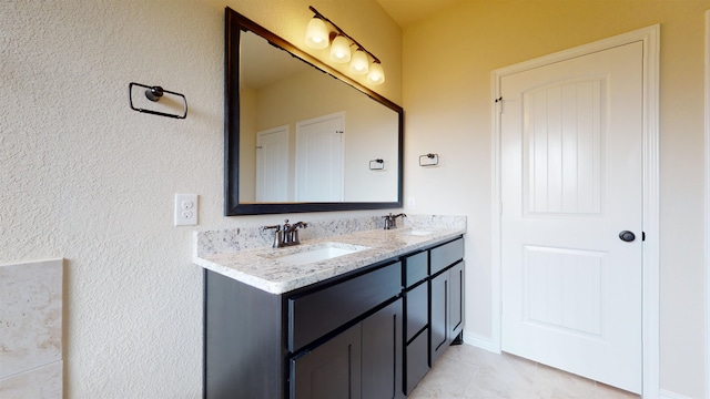 175 Sycamore Ct, Lumberton, TX 77657 - full bathroom featuring double vanity, a textured wall, and tile patterned floors