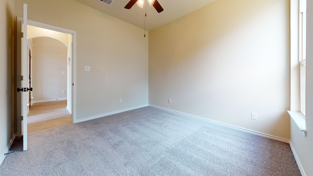 175 Sycamore Ct, Lumberton, TX 77657 - empty room with arched walkways, a ceiling fan, and light colored carpet