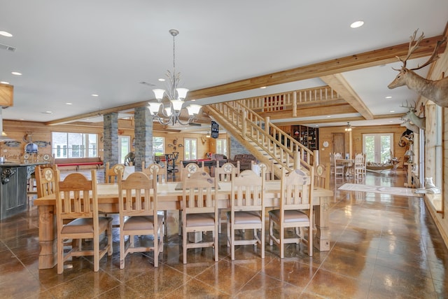 dining area featuring decorative columns, beamed ceiling, and a notable chandelier