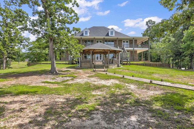 view of front facade with a gazebo and a front lawn