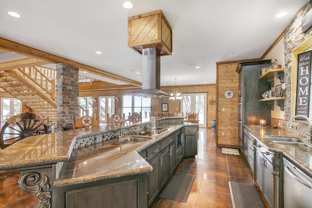 kitchen featuring a large island, dark stone countertops, wood walls, a breakfast bar area, and island range hood