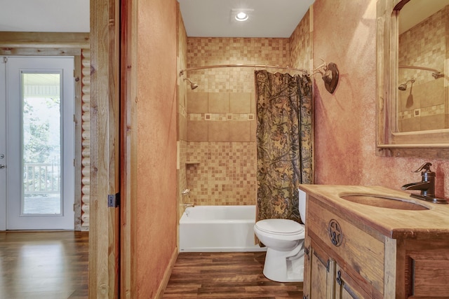 full bathroom with shower / bath combo, vanity, hardwood / wood-style flooring, and toilet