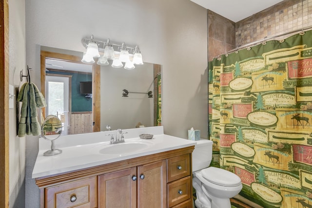 bathroom featuring vanity, toilet, and walk in shower