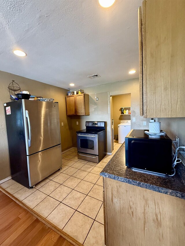 197 Osborne Dr, Bridge City, TX 77611 - kitchen with appliances with stainless steel finishes, dark countertops, washer / clothes dryer, recessed lighting, and baseboards