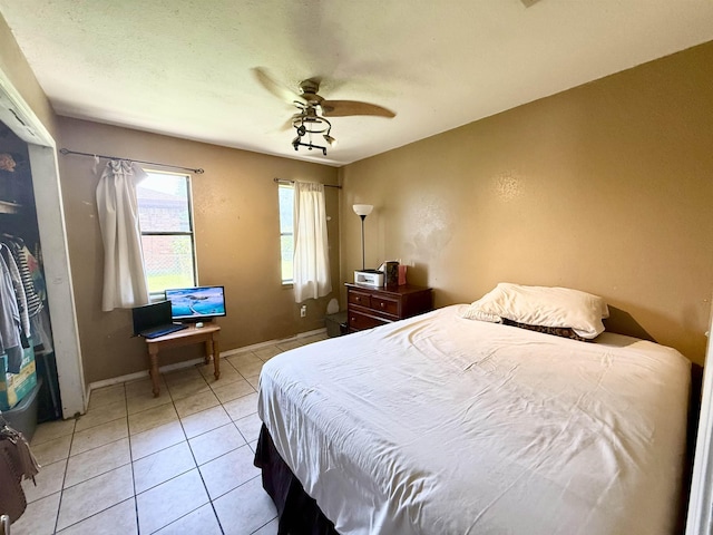 197 Osborne Dr, Bridge City, TX 77611 - bedroom with light tile patterned flooring, baseboards, and a ceiling fan